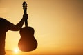 Young man`s hand holding guitar, copy space Royalty Free Stock Photo