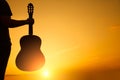 silhouette of young man`s hand holding guitar