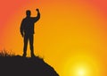 Silhouette of man on the cliff with fist raised up on golden sunrise background, successful, achievement and winning concept