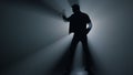 Silhouette man holding knife in hand in darkness. Criminal standing with dagger. Royalty Free Stock Photo