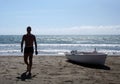 Silhouette of young man walking on a beach Royalty Free Stock Photo