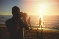 Silhouette of young photographer on the beach Royalty Free Stock Photo