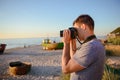 Silhouette of young photographer on the beach Royalty Free Stock Photo