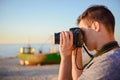 Silhouette of young photographer on the beach Royalty Free Stock Photo