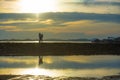 Silhouette of young romantic couple holding and playing with son or daughter little baby enjoying sunset having a walk at beach Royalty Free Stock Photo