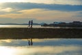 Silhouette of young romantic couple holding and playing with son or daughter little baby enjoying sunset having a walk at beach Royalty Free Stock Photo