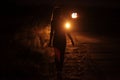 Silhouette of young slender woman in the backlight of car headlights on the road Royalty Free Stock Photo