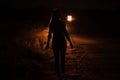 Silhouette of young slender woman in the backlight of car headlights on the road Royalty Free Stock Photo