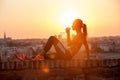 Silhouette of a young sportive woman drinking water