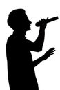 Silhouette of a young talented man singing into a microphon