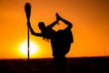 Silhouette of young witch dancing on the broomstick