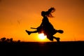 Silhouette of young witch flying on the broomstick