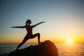 Silhouette of young woman doing fitness exercises on the ocean beach Royalty Free Stock Photo