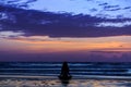 Silhouette young woman doing yoga on the beach at sunset Royalty Free Stock Photo