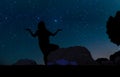 Silhouette of young woman doing yoga practice on the sand hill beneath the stars, Royalty Free Stock Photo