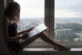 Silhouette of young woman is drawing a watercolor painting on paper. The female artist paints watercolour landscape Royalty Free Stock Photo