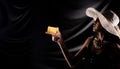 Silhouette of young woman hold gold credit card buy sell online over drape curtain black background Royalty Free Stock Photo