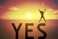 Silhouette young woman jumping and raising up her hand about happy concept on YES text over a beautiful sunset or sunrise Royalty Free Stock Photo