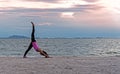 Silhouette young woman lifestyle exercising vital meditate and practicing yoga ball on the beach at sunset. Royalty Free Stock Photo