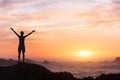 Silhouette of young woman with open arms facing the sea at sunset Royalty Free Stock Photo