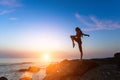 Silhouette of a young woman performing fitness exercises on the sea coast Royalty Free Stock Photo