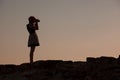 Silhouette of young woman photographer, taking pictures Royalty Free Stock Photo