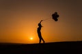 Silhouette of a young woman playing with balloons at sunset Royalty Free Stock Photo