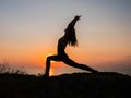 Silhouette young woman practicing yoga on the beach above sea at amazing sunset. fitness, sport, yoga and healthy Royalty Free Stock Photo