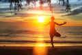 Silhouette young woman practicing yoga on the beach at sunset. Nature. Royalty Free Stock Photo