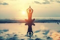 Silhouette young woman practicing yoga on the beach at sunset. Nature. Royalty Free Stock Photo