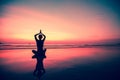 Silhouette young woman practicing yoga on the beach at sunset. Nature. Royalty Free Stock Photo