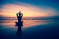 Silhouette young woman practicing yoga on the beach at surrealistic sunset. Relax. Royalty Free Stock Photo