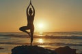 Silhouette of young woman practicing yoga at coastline beach Royalty Free Stock Photo