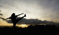 Silhouette of young woman practicing yoga outdoor. Female happiness. Sport and healthy concept