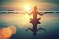 Silhouette young woman practicing yoga on the sea beach at amazing sunset. Relax. Royalty Free Stock Photo