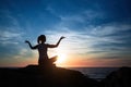 Silhouette young woman practicing yoga on the sea beach Royalty Free Stock Photo