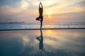 Silhouette young woman practicing yoga on swimming pool Royalty Free Stock Photo