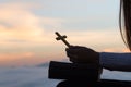 Silhouette of young woman praying with crosses and bibles at sunrise, Christian Religion concept background Royalty Free Stock Photo