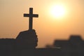 Silhouette of young woman praying with crosses and bibles at sunrise, Christian Religion concept background Royalty Free Stock Photo