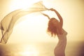 Silhouette of young woman relaxing at the beach