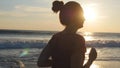 Silhouette of young woman running on sea beach at sunset. Girl jogging along ocean shore during sunrise. Female Royalty Free Stock Photo