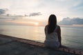 Silhouette of young woman sitting alone on back side outdoor at Royalty Free Stock Photo