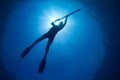 A silhouette of a young woman spearfishing Royalty Free Stock Photo