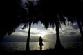 Silhouette of young woman, standing exercise    alone by the sea, exercise Royalty Free Stock Photo