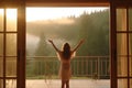 Silhouette of young woman standing in front of the window and looking at the foggy mountains with Generative AI. Royalty Free Stock Photo