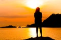 Silhouette of young woman standing at relax pose or freedom pose or chill pose Royalty Free Stock Photo