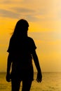 Silhouette of young woman standing at relax pose or freedom pose or chill pose Royalty Free Stock Photo