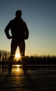 Silhouette of young woman at sunset