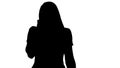 Silhouette Young Woman Talking to Someone on her Mobile Phone. Royalty Free Stock Photo