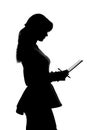 Silhouette of a young woman thinking whether to accept the offer and whether to sign a document which is already in her hands Royalty Free Stock Photo